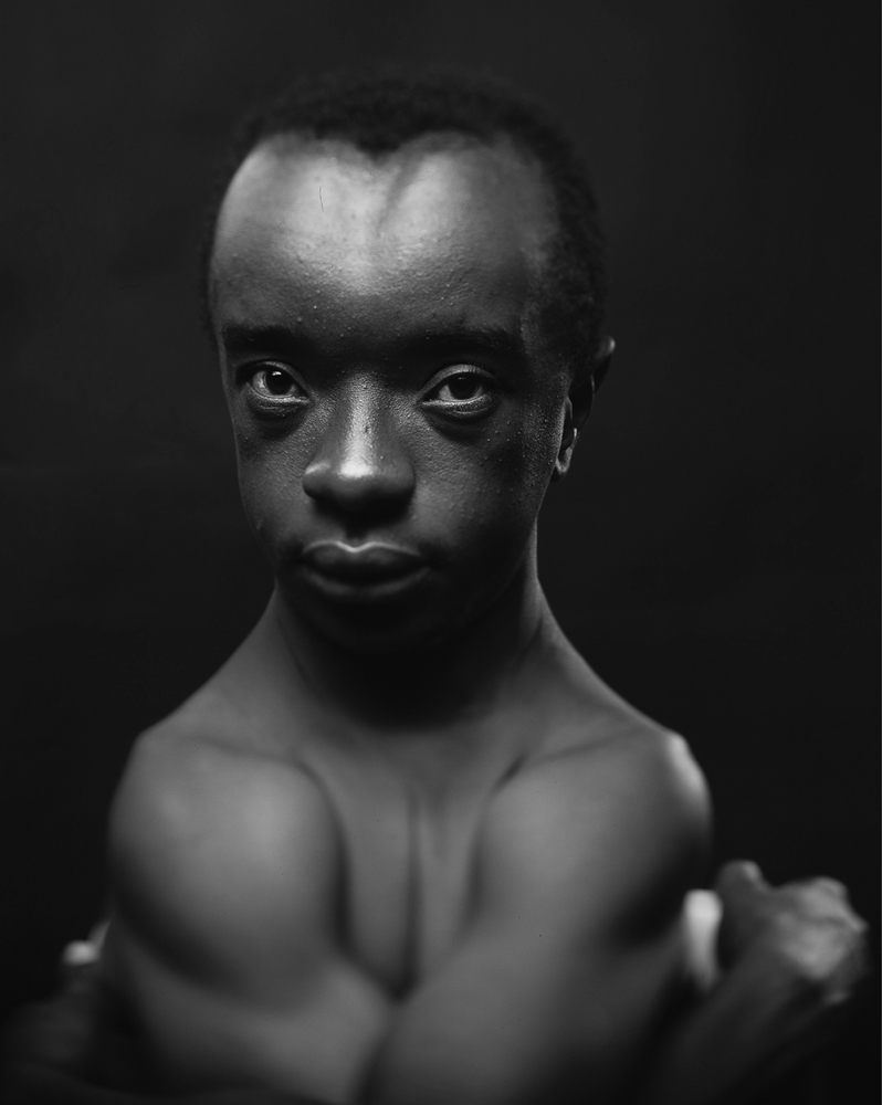 Black and white photo of a man staring at the camera